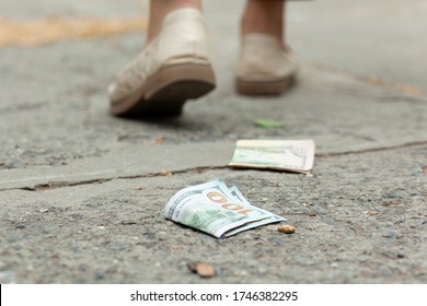 Woman And Money On The Ground In Street