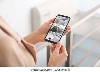 Woman Monitoring Modern Cctv Cameras On Smartphone Indoors, Closeup. Home Security System