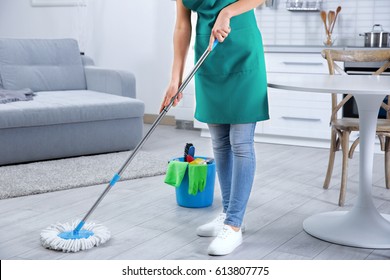 Woman With Mop Cleaning Home