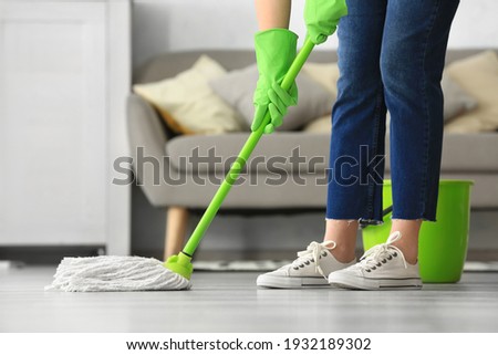 Woman mopping floor in room Imagine de stoc © 