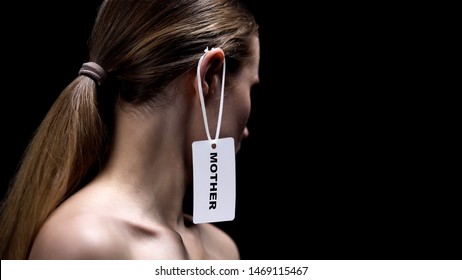 Woman With Mother Tag On Ear Against Black Background, Gender Stereotypes