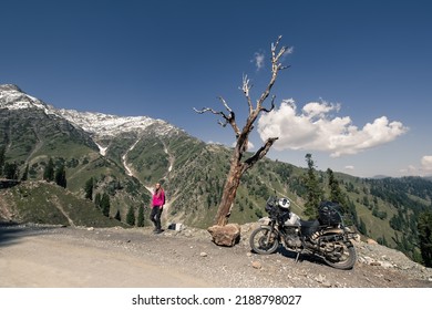 Woman Motorcyclist Resting In Moto Travel In Himalaya Mountains Near Dry Tree