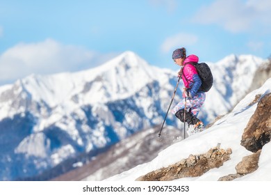 Woman Mountaineer Downhill With Crampons On Snowy Slope