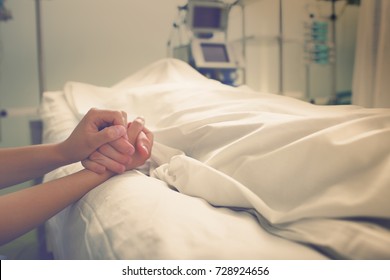 Woman mourns her husband, who died in a hospital. - Shutterstock ID 728924656