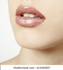 Woman Mouth Close Up With Pink Metallic Lipstick