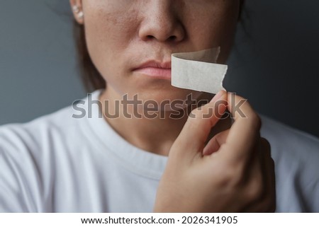 woman with mouth sealed in adhesive tape. Free of speech, freedom of press, Human rights, Protest dictatorship, democracy, liberty, equality and fraternity concepts