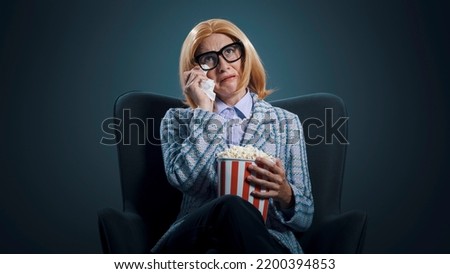 Woman at the movie theater, she is watching a drama movie and crying, cinema and entertainment concept