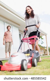 Woman Mowing Green Lawn