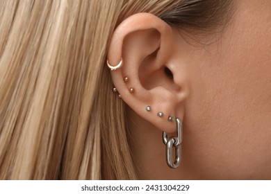 Woman with multiple ear piercing, closeup