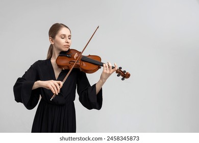 Woman musical artist playing violin - Powered by Shutterstock