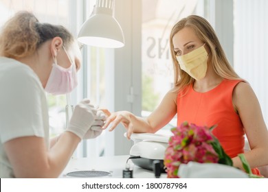 Woman In The Nail Salon Receiving Manicure Wearing A Face Mask During Coronavirus Crisis