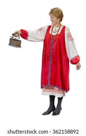 Woman in national historic Russian peasant costume with historical utensils
