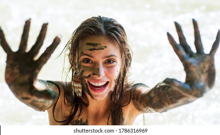 Woman With Natural Mud Mask. Muddy Hands. Spa Outdoor. Happy Dirty Woman In Dead Sea