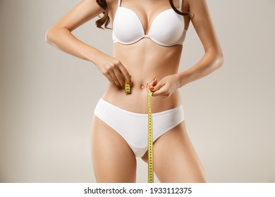 Woman with natural slim tanned body in underwear
