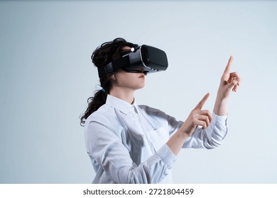 Woman navigating digital interface using virtual reality headset and hand gestures in futuristic technology environment