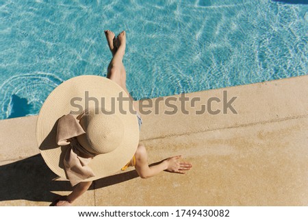 Woman near pool relaxing sun tan luxury
