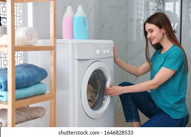Woman near washing machine in bathroom. Laundry day - Shutterstock ID 1646828533