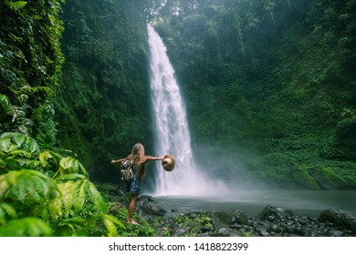 Woman near waterfall on Bali, Indonesia