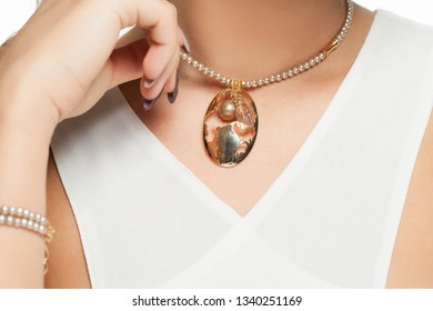 Woman Neck In Gold Necklace With Pearls And Cameo Pendant Closeup