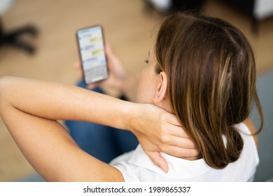 Woman With Neck Pain Sitting Using Mobile Phone