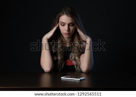 Woman with negative surprised face looking something in smartphone. Sad teenager with mobile phone, scared of threatening,