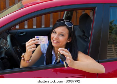 Woman With New Car And Driver\u0026#39;s License And Car Keys