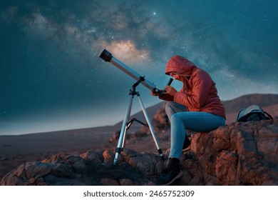 woman next to a telescope observing the night sky in the desert	