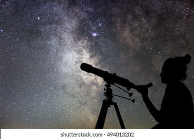 Woman And Night Sky. Watching The Stars Woman With Telescope.
