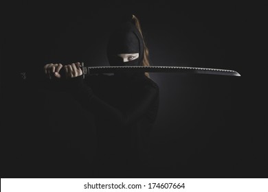 Woman Ninja Cosplay With Katana At The Dark Background