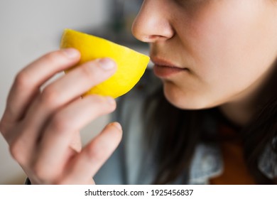 Woman Nose Sniffing Lemon Smell. Coronavirus Symptom