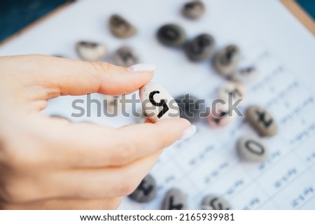 Woman numerologist hand with pebble stone with number five 5. Stock photo © 