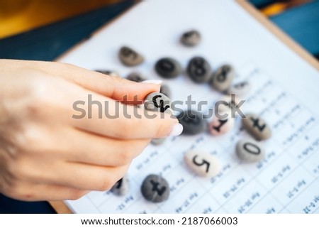 Woman numerologist hand with pebble stone with number three 3. Stock photo © 