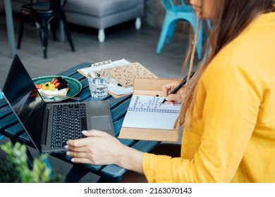 Woman Numerologist Working With Numbers In Notepad And Laptop. Numerology Numbers Concept. Numerology Calculate Life Path And Destiny Numbers.