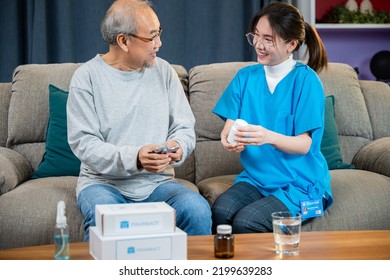 Woman Nurse Caregiver Show Prescription Drug To Senior Man At Nursing Home, Doctor With Physician Visit Senior Male Patient Consult Medicine Dosage At House In Living Room, Healthcare Worker Support