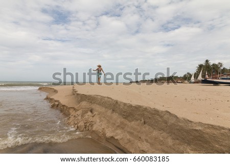 Woman observing the meeting of river waters with the sea
North coastile, Rio Grande do Norte, Brazil.