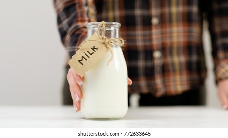 Woman Offering Milk. Quality Dairy Products. Healthy Lifestyle. Calcium And Vitamin D