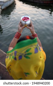 woman offering prayers to ancestors in Ganges river, India - Shutterstock ID 1948940200