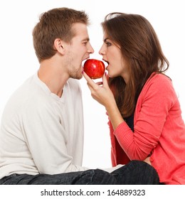 woman offers the man an apple