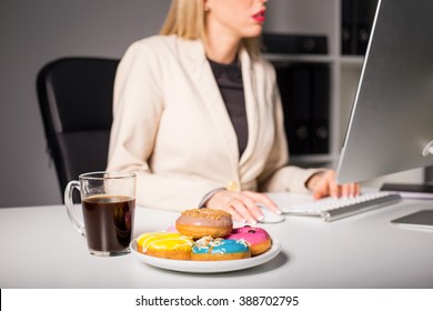 Woman In Office With Coffee And Donuts 