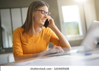 Woman In Office Talking On Phone