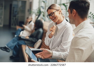 Woman office worker discussing new project with colleague during working day in coworking - Shutterstock ID 2286772587