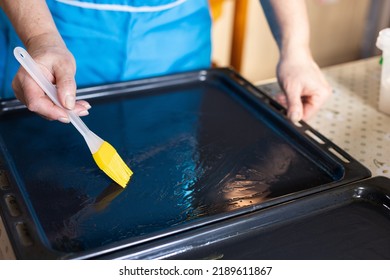 Woman Oiling Baking Sheet. Baking At Home.