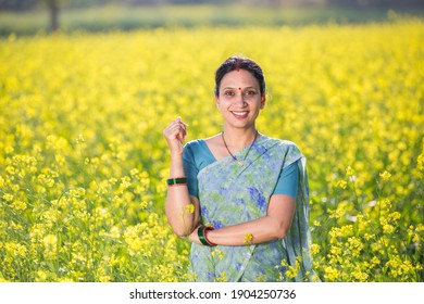 Woman in oilseed rape agricultural field - Powered by Shutterstock