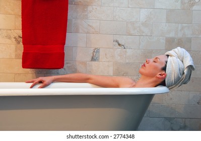 Woman In Old Fashion Clawfoot Tub.