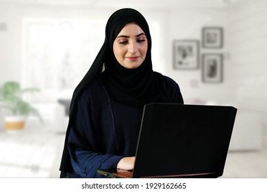 Woman on Abaya Hijab working on duty using laptop computer, Working from home remotely concept