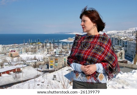 Woman on background of the port-city Kholmsk, island Sakhalin.