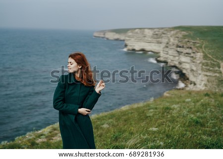 Woman on the background of the sea in nature, fresh air                               