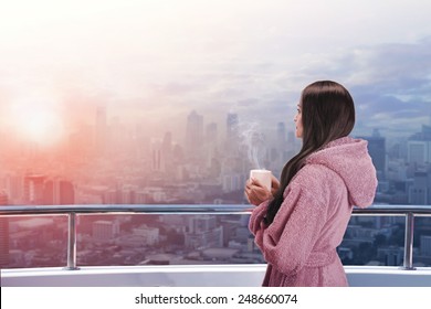 Woman On The Balcony Enjoying City View