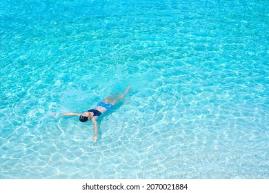the woman on the beach, clear water sea with blue sky on the Holiday, swim on the turquoise water beach, at koh nang yuan island beach, koh tao ,suratthani , thailand