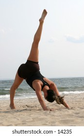 woman on beach doing yoga